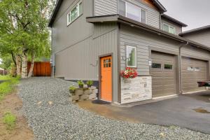una casa con una puerta naranja y un garaje en Anchorage Apartment with a View about 3 Mi to Airport en Anchorage