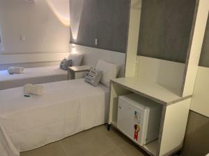 Postel nebo postele na pokoji v ubytování Hotel Dois Irmãos