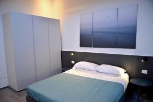 ラツィーゼにあるCasa Narcisoのベッドルーム1室(ベッド1台、上に絵画付)