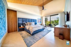 a bedroom with a large bed and a balcony at Sunny Vacation Villa No 31 in Bonao