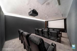 a conference room with black chairs and a screen at Sunny Vacation Villa No 31 in Bonao