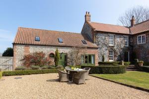a house with a table and chairs in front of it at Riding Stable, Rookery Farm in West Beckham