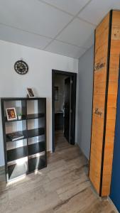 Habitación con pasillo con estanterías de madera y puerta en Estudio Mirador Dorado, en Málaga