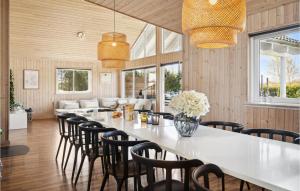 a large dining room with a long table and chairs at Lovely Home In Idestrup With Private Swimming Pool, Can Be Inside Or Outside in Bøtø By