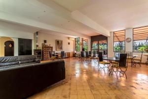 a living room with a couch and tables and chairs at Riad le Ksar de Fes in Ain Cheggag