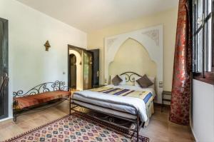 a bedroom with a bed in a room at Riad le Ksar de Fes in Aïn Cheggag