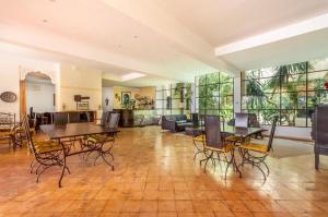 a large living room with tables and chairs in it at Riad le Ksar de Fes in Aïn Cheggag