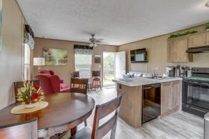 a kitchen and living room with a wooden table and a dining room at Rural Mt Olive Cabin Rental with White River View! in Melbourne +16 photos