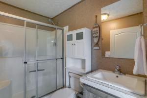 a bathroom with a shower and a toilet and a sink at Rural Mt Olive Cabin Rental with White River View! in Melbourne