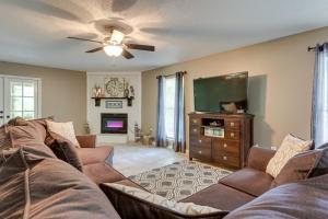a living room with a couch and a flat screen tv at Peaceful Lucedale Hideaway on Private Acerage! in Lucedale