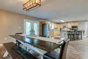 a kitchen with a large wooden table in a room at Peaceful Lucedale Hideaway on Private Acerage! in Lucedale