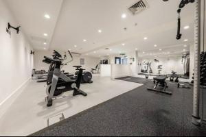 a gym with treadmills and elliptical machines in a room at 1 bed Apartment with parking & GYM in Slough