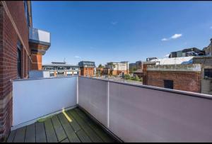 a balcony with a view of a city at 1 bed Apartment with parking & GYM in Slough