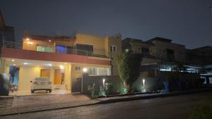 a car parked in front of a house at night at Secure Inn Hotel in Rawalpindi