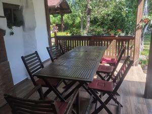 a wooden table and chairs sitting on a deck at Vitanova Guest House in Genchovtsi