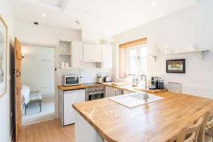 a kitchen with a wooden counter top in a room at Olive in Oundle