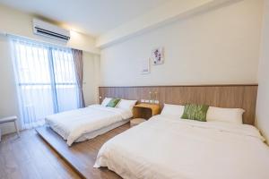 Een bed of bedden in een kamer bij 悠日 Lazy Days 澎湖民宿