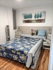 1 dormitorio con 1 cama con manta azul y blanca en Apartamento Romántico, en Los Realejos