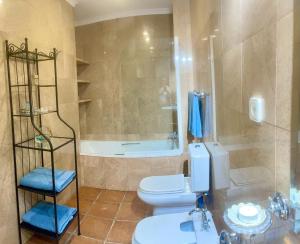a bathroom with a toilet and a sink and a shower at Casa Junto al Mar in La Herradura +37 photos