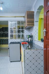 a kitchen with yellow and white tiles and a counter at Entire Fully furnished Villas in Kisii in Kisii