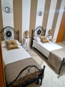 two beds sitting next to each other in a bedroom at MARY FAMILY HOME in Polverigi