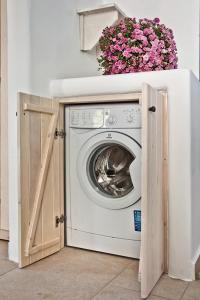 a washer and dryer in a room with a window at Villa Stamatina in Kyra Panagia