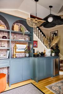 a kitchen with blue cabinets and a ceiling at The Coco, The Edgartown Collection in Edgartown