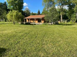 a house in a field with a large yard at Les Grozilles in Feuillade