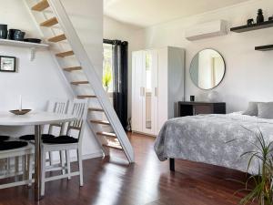 1 dormitorio con cama, mesa y escalera en Holiday home RÖNNÄNG VI, en Rönnäng