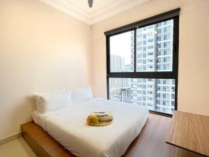 a bedroom with a white bed and a large window at Vsummer, Homely Suite by Antlerzone in Johor Bahru