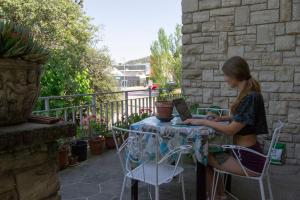 una mujer sentada en una mesa con un libro en Habitació V Cal Kim, en Martorell