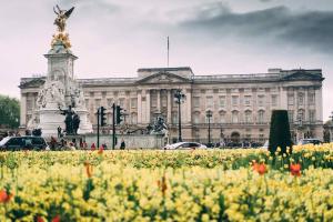 a large building with a field of flowers in front of it at Pass the Keys Kings Cross City Escape in London