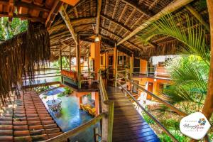 an overhead view of a house with a wooden deck at Pousada Manga Rosa in Ilhabela