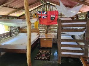 a room with two bunk beds and a flag at Rio Escondido in Minca