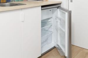 um frigorífico branco com a porta aberta numa cozinha em Pátio C'un Casinhas em Nazaré