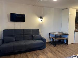 a living room with a couch and a table at HAVANA du Futuroscope in Chasseneuil-du-Poitou +2 photos