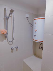 a shower in a white bathroom with a bucket at Fahrenheit 88 Pavillion By Abby comfy stay in Kuala Lumpur