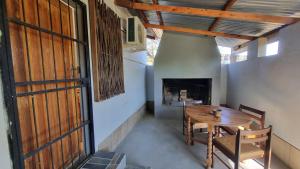 a dining room with a table and a fireplace at Botuin Cottages in Vanrhynsdorp