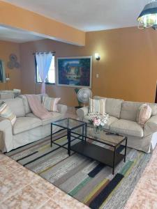 a living room with two couches and a coffee table at Casa Francesca in Boca Chica
