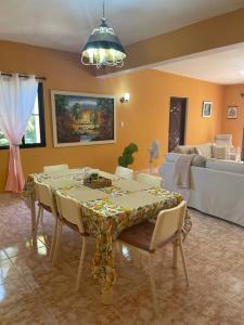 a dining room with a table and a couch at Casa Francesca in Boca Chica
