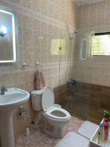 a bathroom with a toilet and a shower and a sink at Casa Francesca in Boca Chica