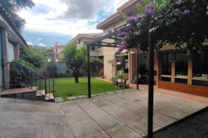 a courtyard of a house with trees and purple flowers at Casa 363/ 2-8 personas in Tarija