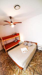 a bedroom with a bed and a ceiling fan at Hotel Parque in Necochea