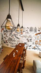 a wooden table in a room with a wall with graffiti at Hotel Parque in Necochea