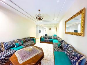 a living room with couches and a mirror at Luxury of Mesnana in Tangier