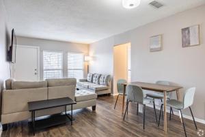 a living room with a couch and a table and chairs at The Avery in Atlanta