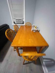a wooden dining table with chairs and a window at THE ECO HOME. Entire place with private parking in Wilmington