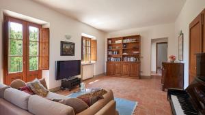 a living room with a couch and a flat screen tv at San Demetrio in Castelnuovo Berardenga