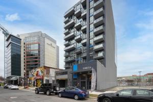 a parking lot with cars parked in front of a building at Global Luxury Suites at Tribeca in Washington