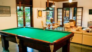 a pool table in the middle of a living room at Canto das Laranjeiras Beach Club Guaiuba in Guarujá